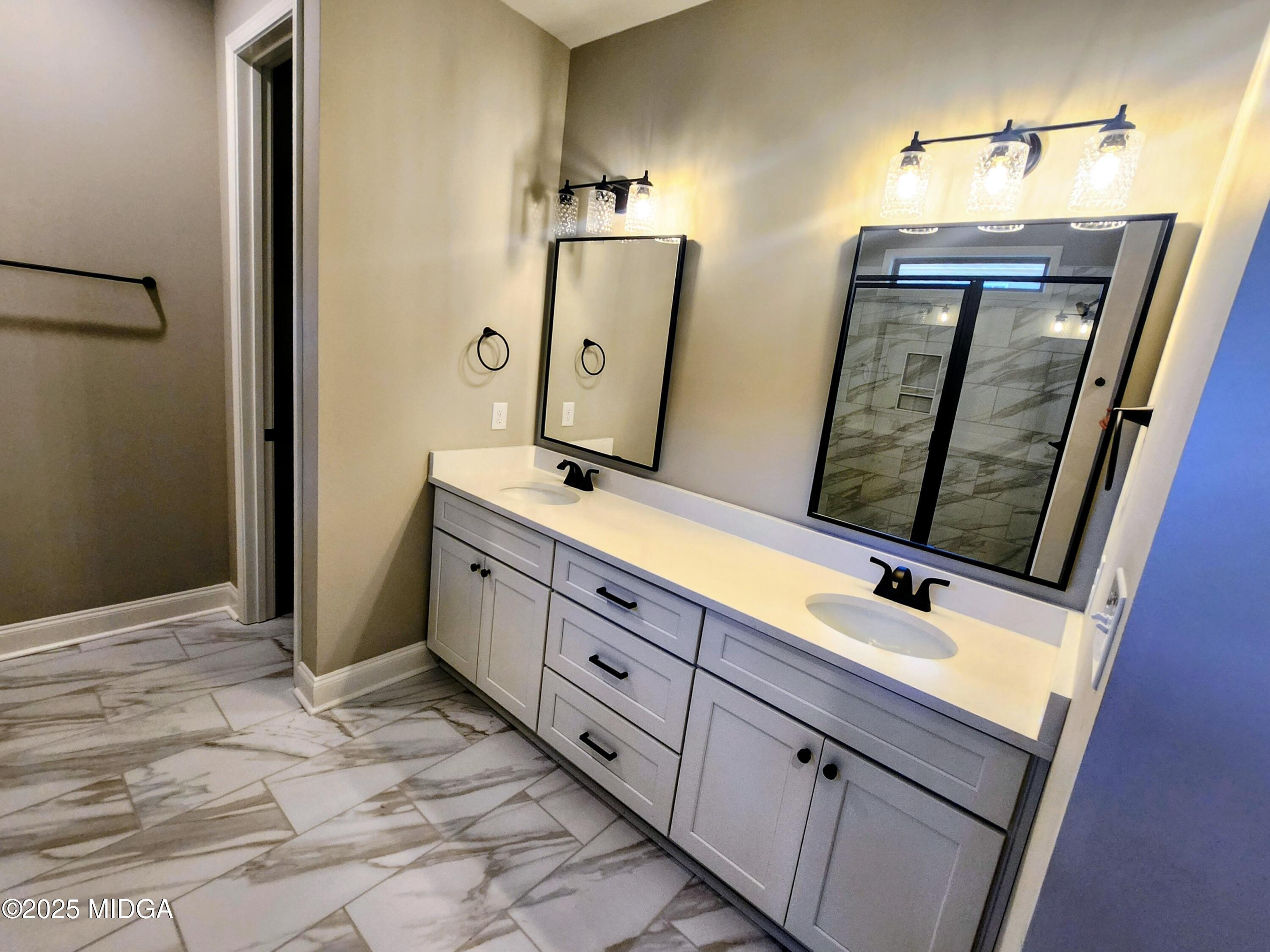 404 Minter Drive Warner Robins, GA 31088 - Photo 38 of 60 a bathroom with double vanity sink and two mirror