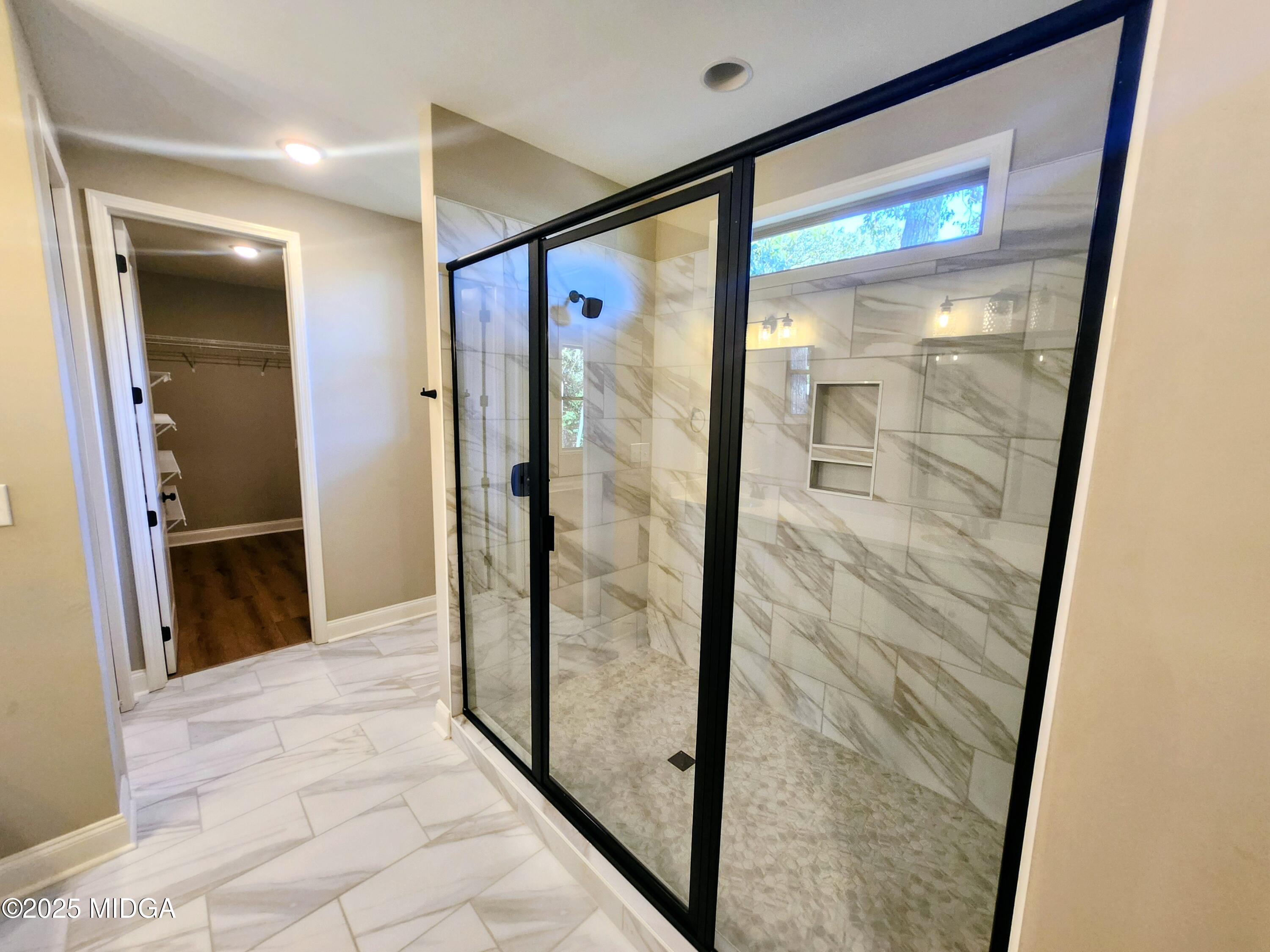 404 Minter Drive Warner Robins, GA 31088 - Photo 40 of 60 a bathroom with a glass shower door and mirror