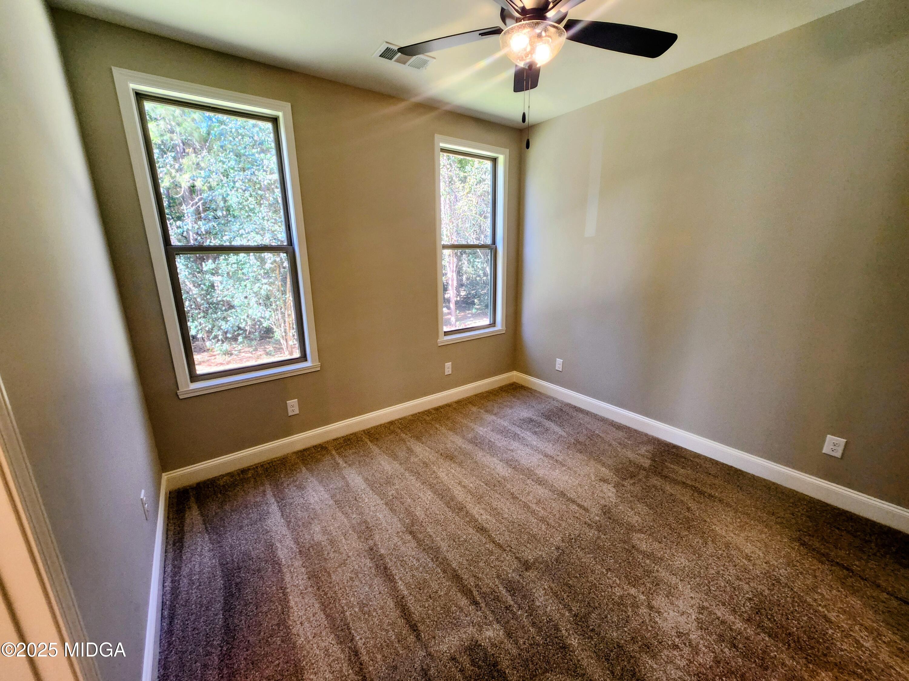 404 Minter Drive Warner Robins, GA 31088 - Photo 43 of 60 a view of an empty room with window and wooden floor