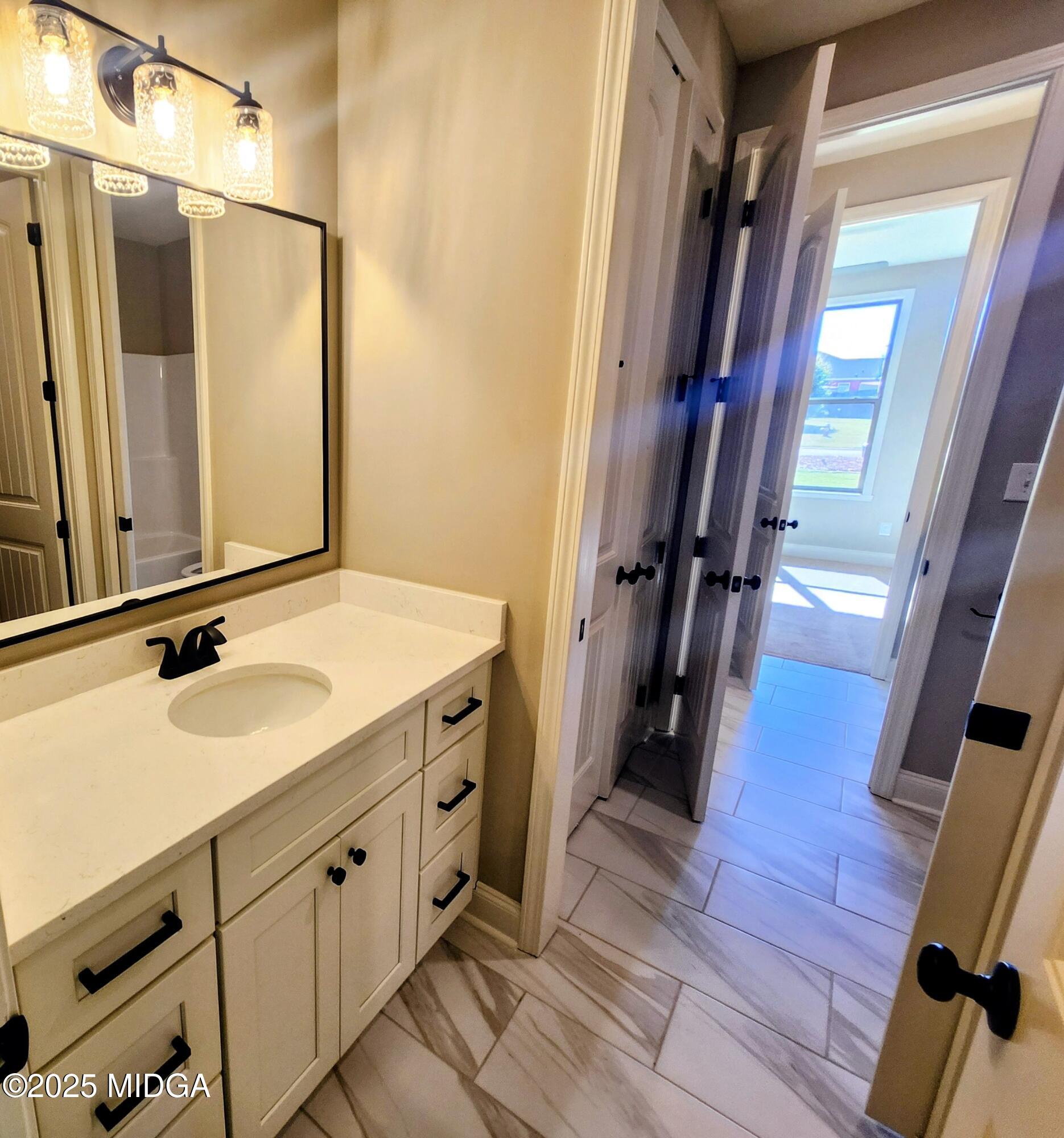 404 Minter Drive Warner Robins, GA 31088 - Photo 44 of 60 a bathroom with a sink a mirror and a shower