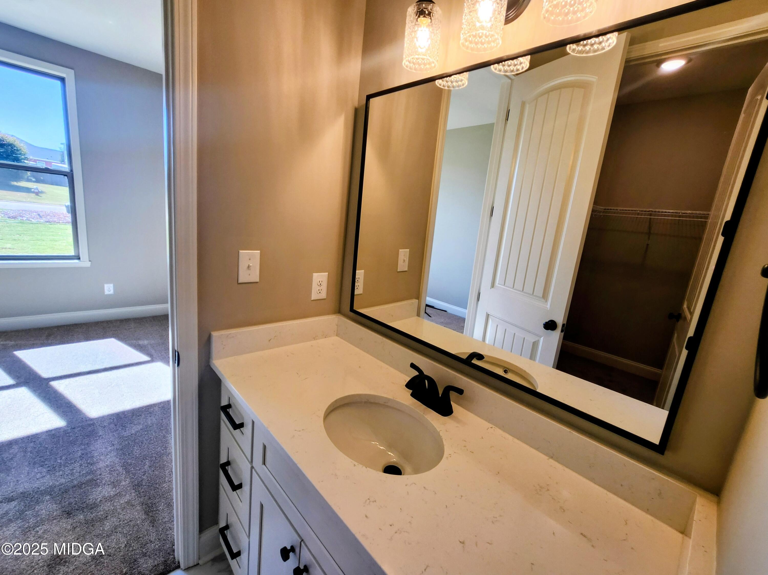 404 Minter Drive Warner Robins, GA 31088 - Photo 47 of 60 a bathroom with a granite countertop sink a mirror and shower