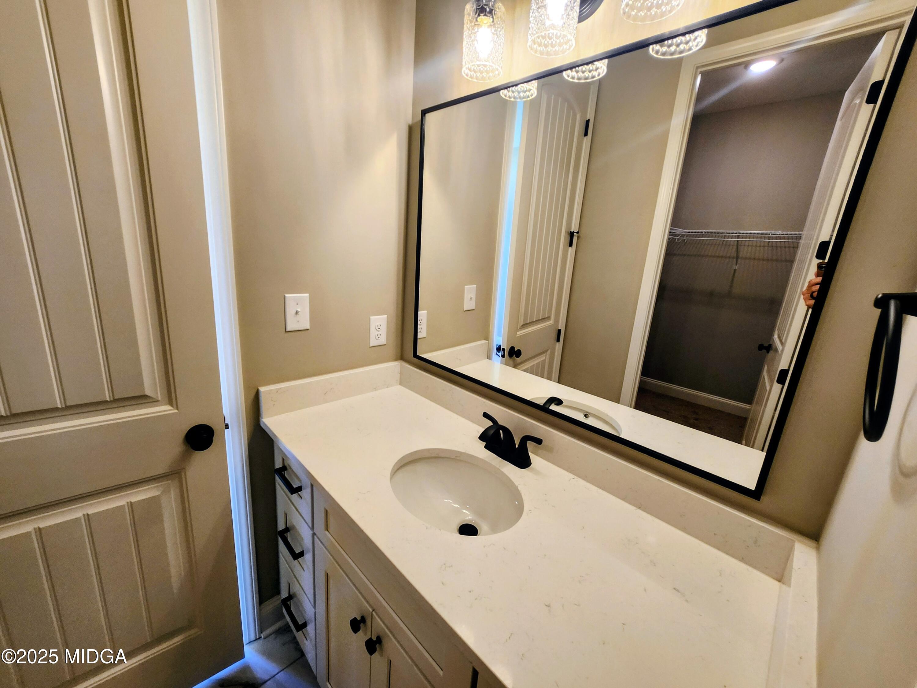 404 Minter Drive Warner Robins, GA 31088 - Photo 48 of 60 a bathroom with a sink a mirror and a window