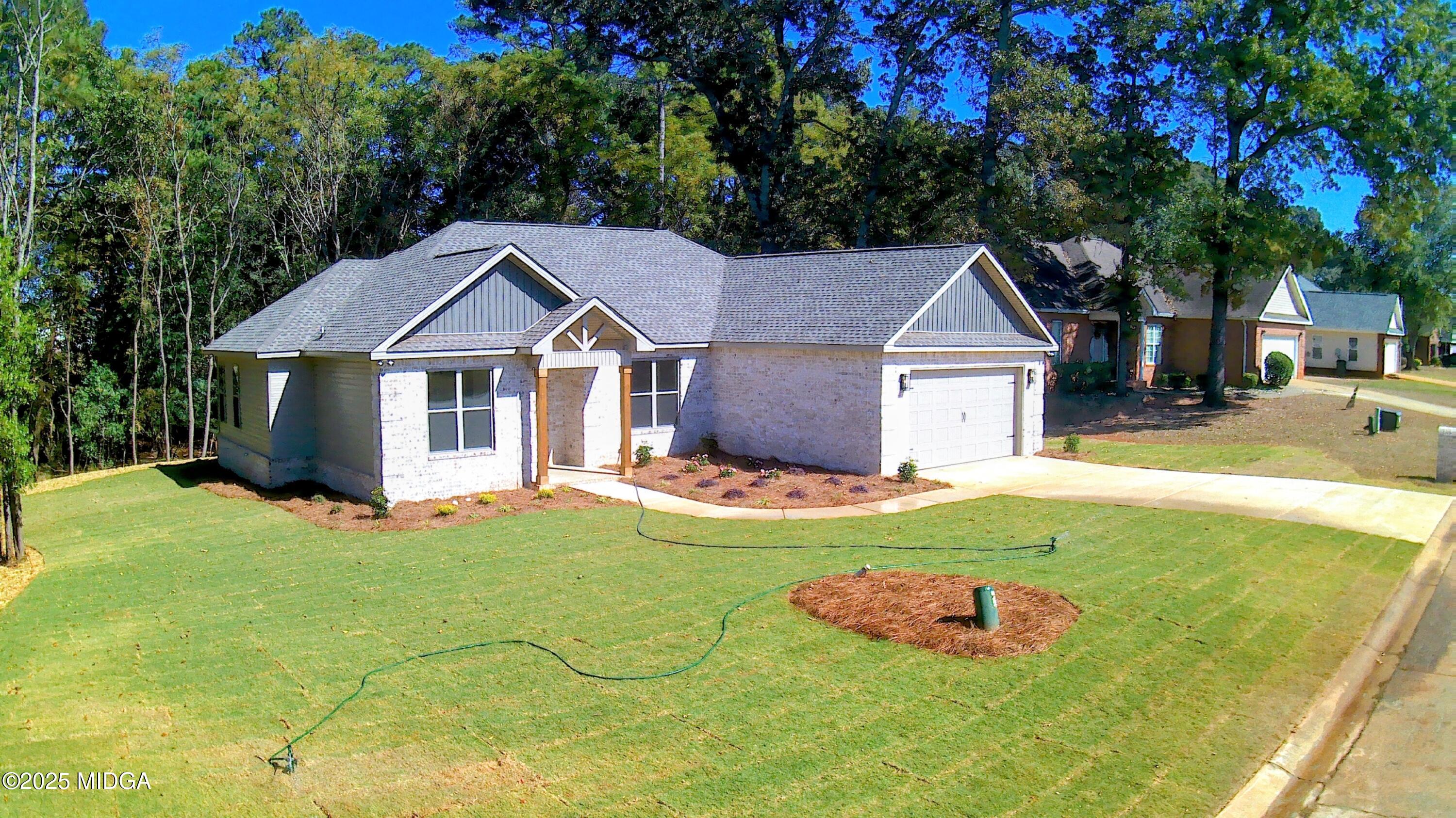 404 Minter Drive Warner Robins, GA 31088 - Photo 6 of 60 a front view of a house with yard and green space