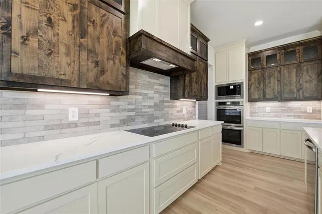 a kitchen with a sink cabinets and appliances