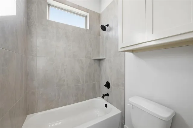 a bathroom with a bathtub and shower