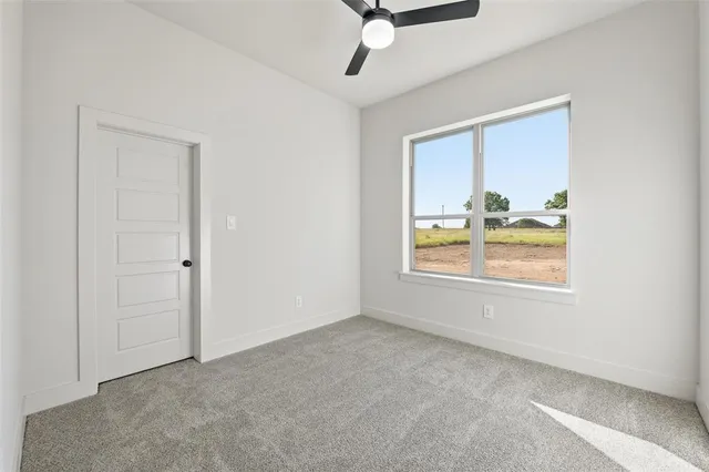 an empty room with windows and cabinet
