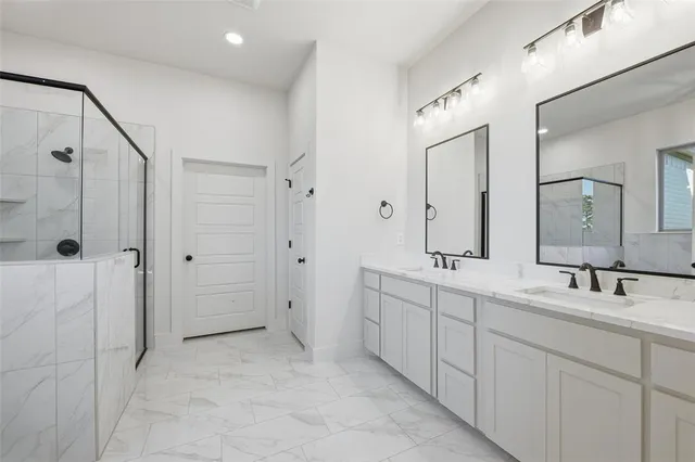 a bathroom with a double vanity sink mirror and double