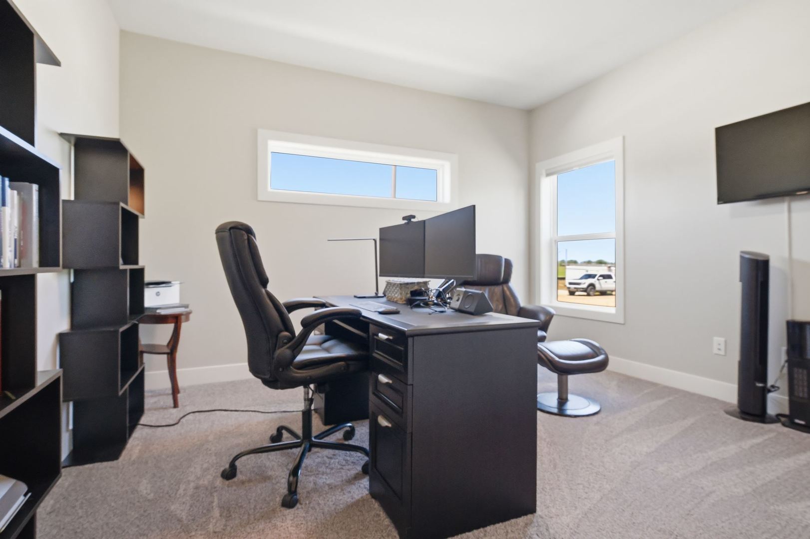1216 Granite Way Normal, IL 61761 - Photo 5 of 33 a view of a workspace with furniture and a flat screen tv
