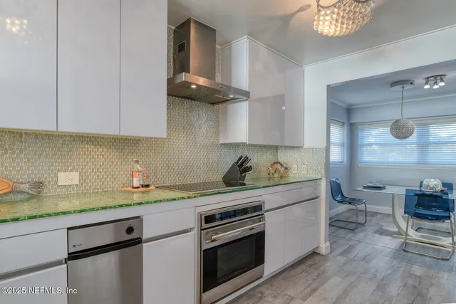 a kitchen with stainless steel appliances granite countertop a sink and a stove