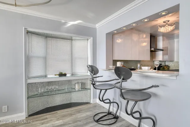 a living room with furniture and a dining table with kitchen view