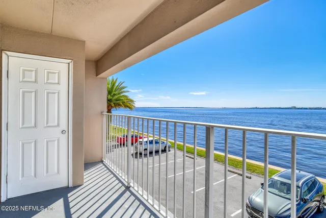 a view of balcony with a floor to ceiling window and wooden floor