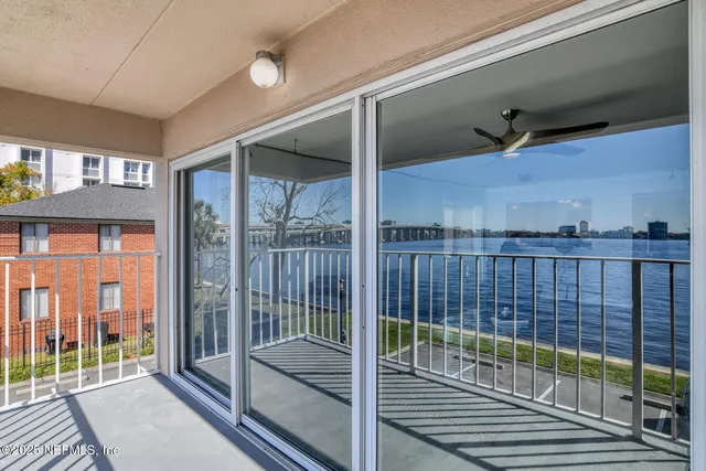 a bedroom with a bed and a flat tv screen on the dresser
