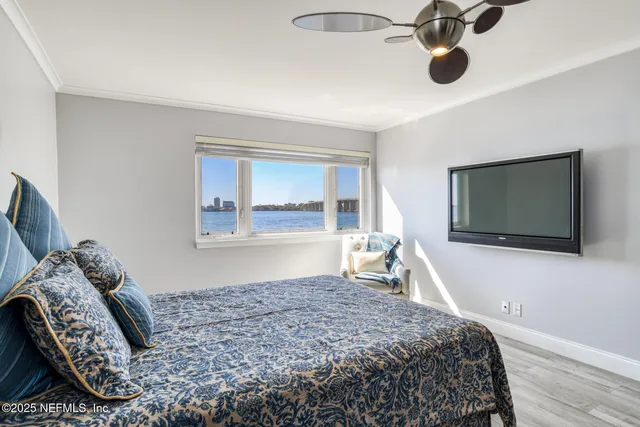 a bedroom with a bed and wooden floor