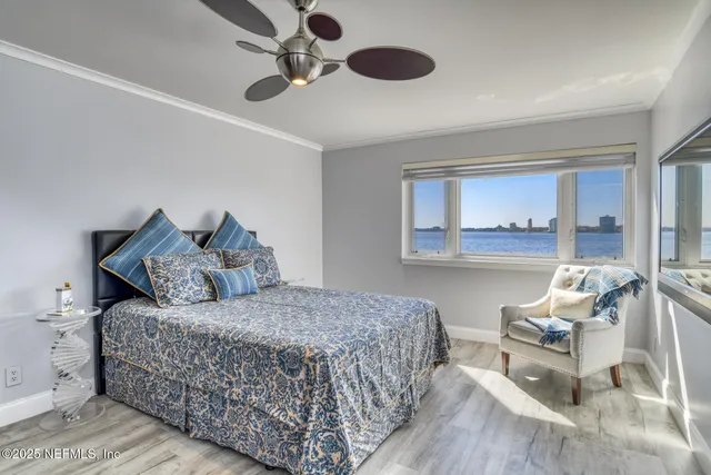 a bedroom with a bed and wooden floor