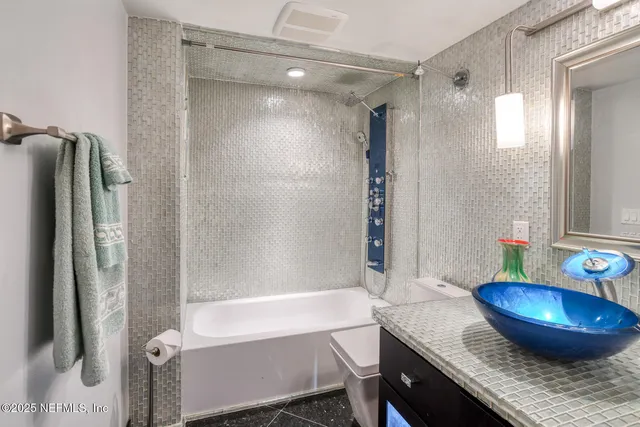 a bathroom with a shower and a sink