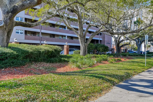 a front view of a building with a garden