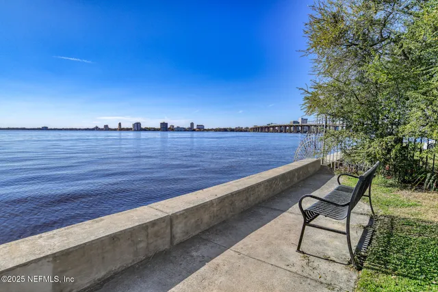 a view of a lake with houses in the back