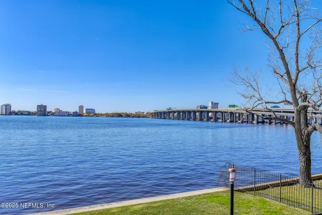 a view of a street with a building and a big yard
