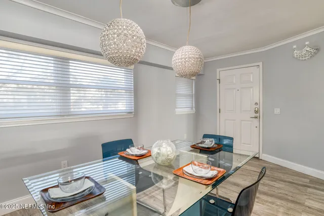 a view of a dining room with furniture wooden floor and chandelier