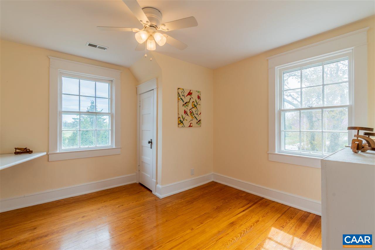 4308 Millington Road Free Union, VA 22940 - Photo 25 of 43 a view of an empty room with a window and wooden floor