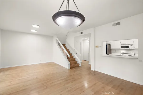 a view of an empty room and wooden floor