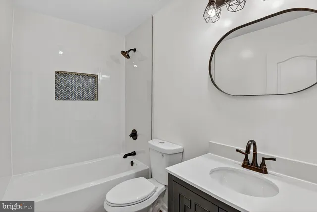 a bathroom with a toilet sink and a mirror