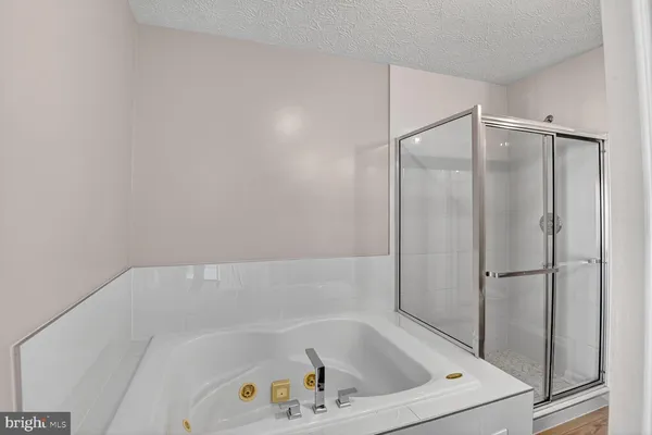 a bathroom with a tub and shower