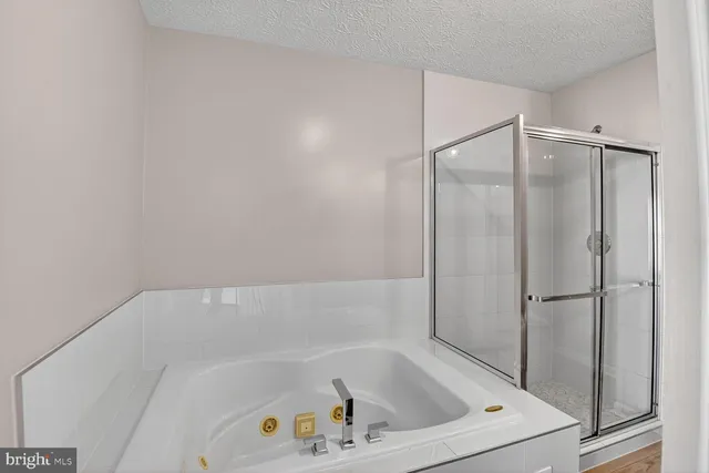 a bathroom with a tub and shower