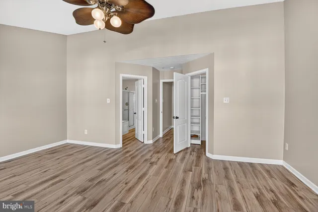 a view of an empty room and wooden floor