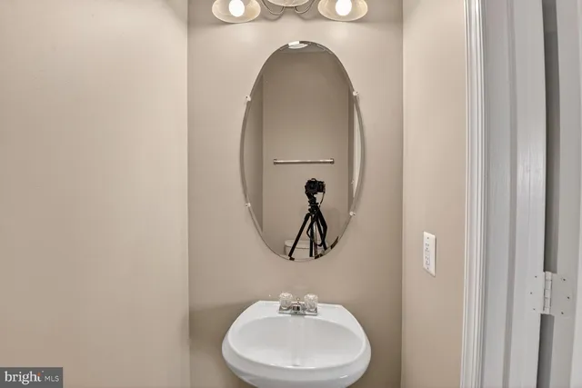 a bathroom with a toilet and a mirror