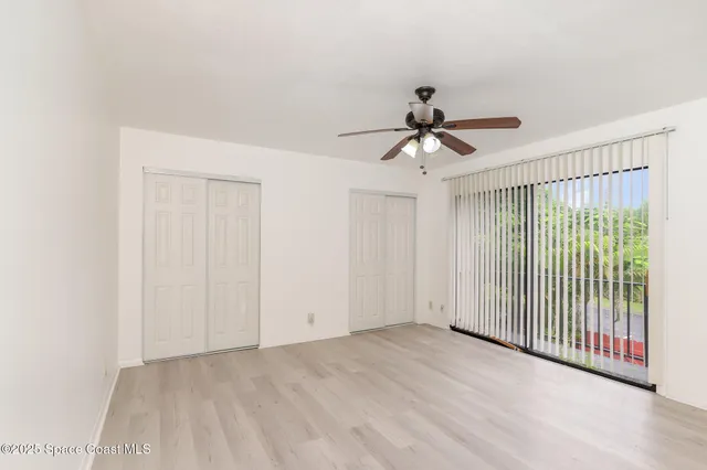 a view of a livingroom with a ceiling fan and window