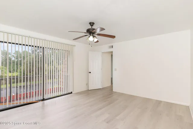a view of a chandelier fan in big room