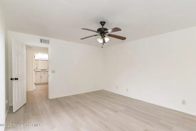 a view of a room with a fan and a ceiling fan