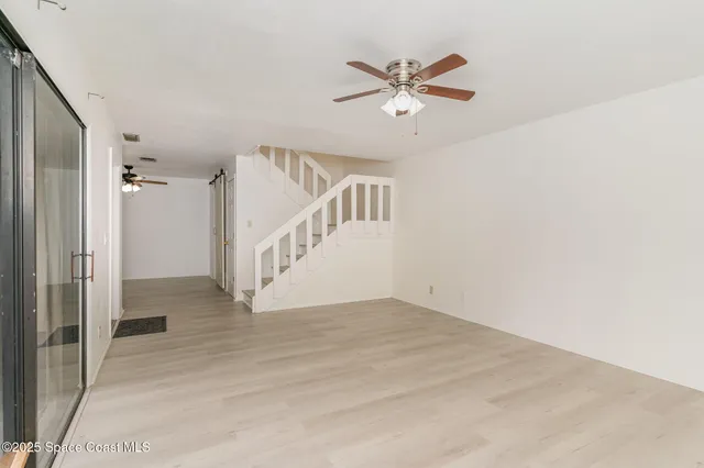 a view of an entryway with wooden floor