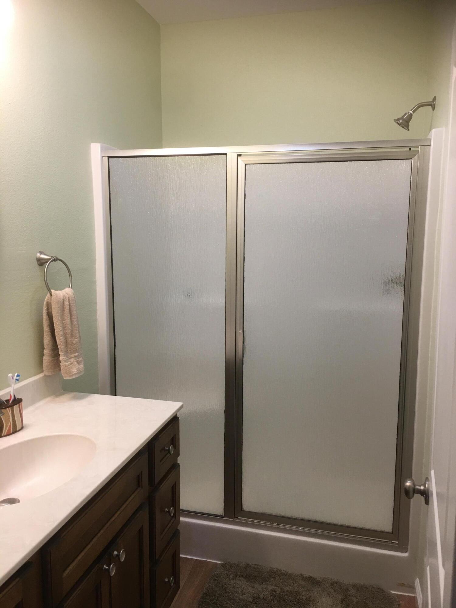 5872 Dairy Road Baker, FL 32531 - Photo 18 of 31 a bathroom with a shower sink and mirror
