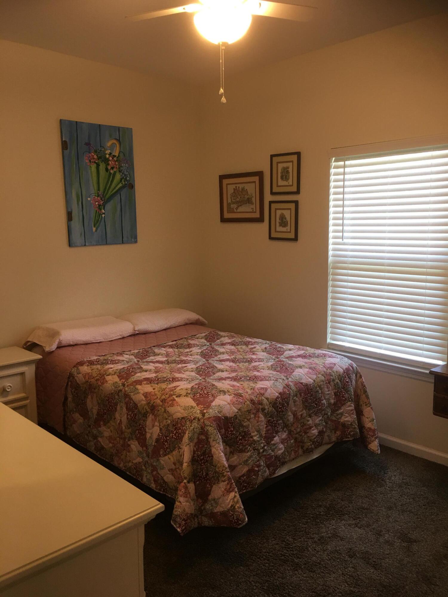 5872 Dairy Road Baker, FL 32531 - Photo 23 of 31 a bedroom with a bed and a window