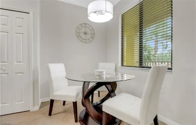 a view of a room with a table and chairs