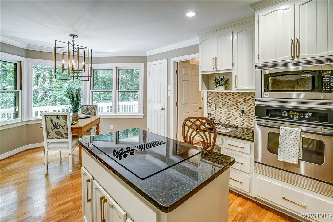 3630 Lansdowne Road Midlothian, VA 23113 - Photo 18 of 50 a living room with stainless steel appliances granite countertop a stove top oven a sink dishwasher a dining table and chairs with wooden floor