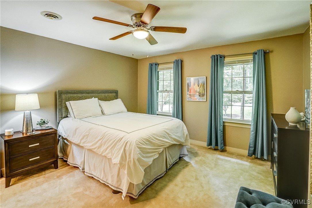 3630 Lansdowne Road Midlothian, VA 23113 - Photo 34 of 50 a spacious bedroom with a bed a window and a chandelier