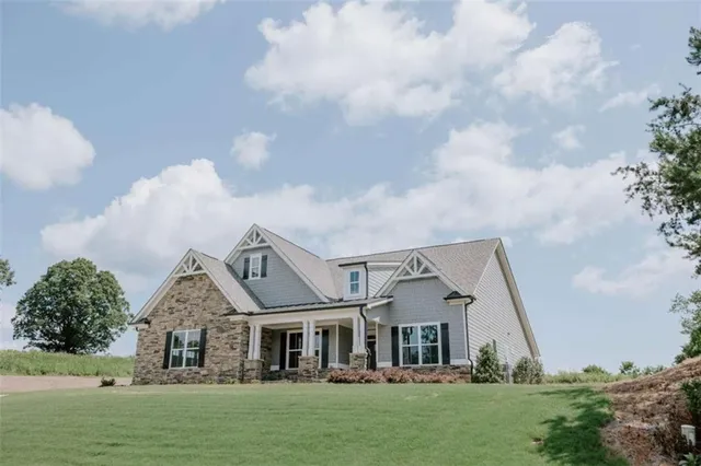 a front view of a house with a garden