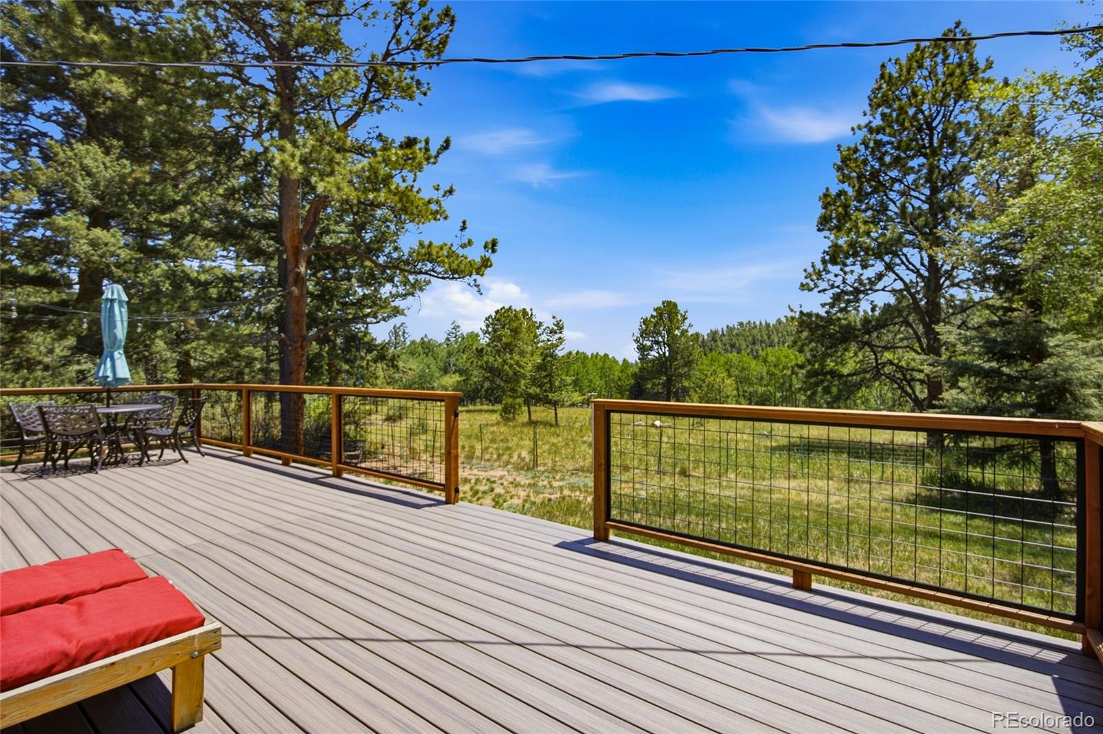 31280 Florence Road Conifer, CO 80433 - Photo 28 of 48 a view of balcony with wooden floor and seating space