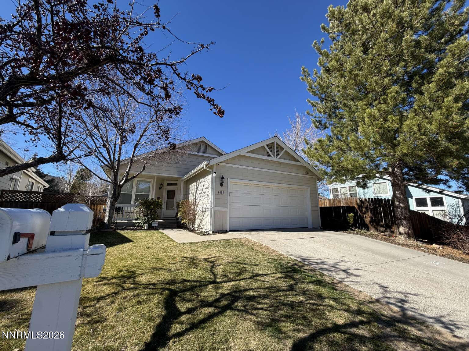 4695 Hampton Lane Reno, NV 89519 - Photo 1 of 20 a front view of a house with a yard covered with snow