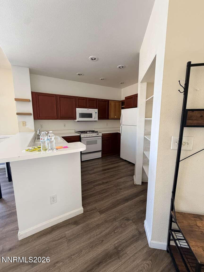 4695 Hampton Lane Reno, NV 89519 - Photo 5 of 20 a room with stainless steel appliances kitchen island granite countertop wooden floors and sink