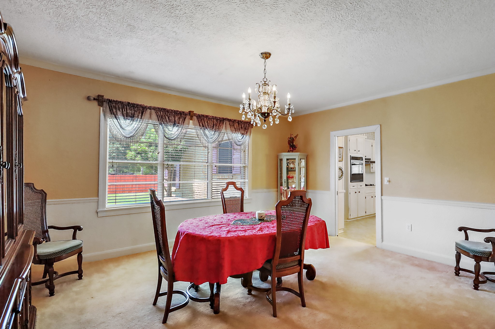 405 Park Street Anahuac, TX 77514 - Photo 12 of 37 a view of a dining room with furniture a chandelier and window
