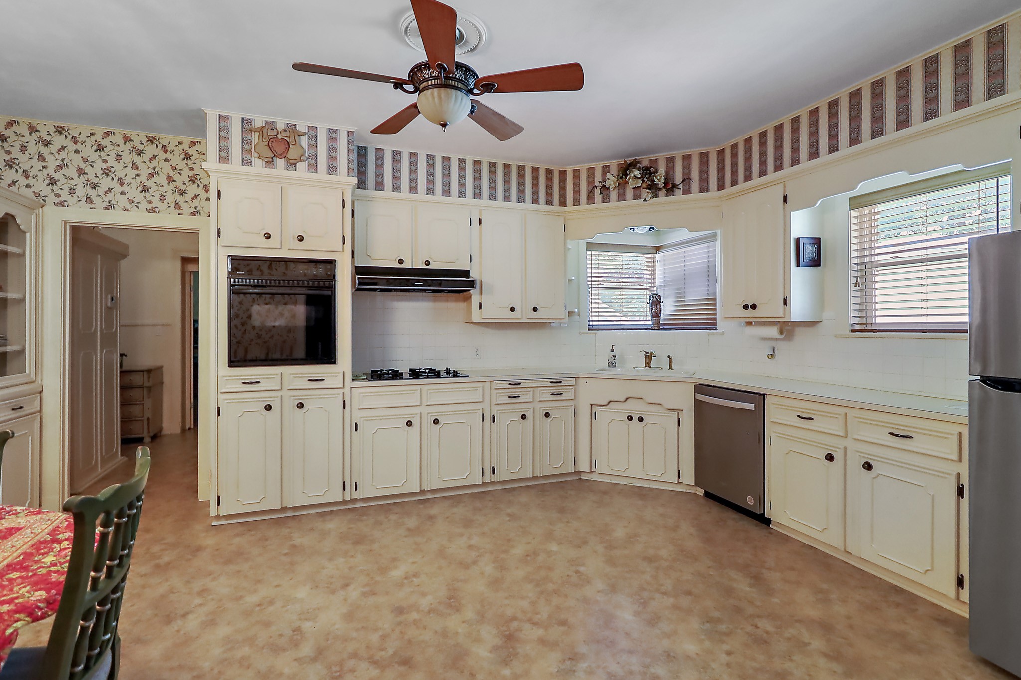 405 Park Street Anahuac, TX 77514 - Photo 13 of 37 a kitchen with cabinets appliances and a window