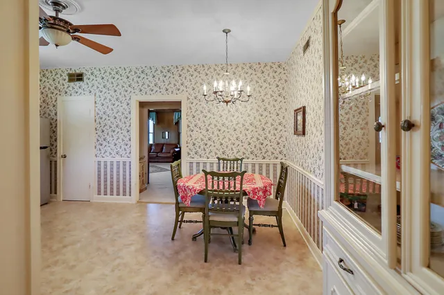 a view of a dining room with furniture and chandelier