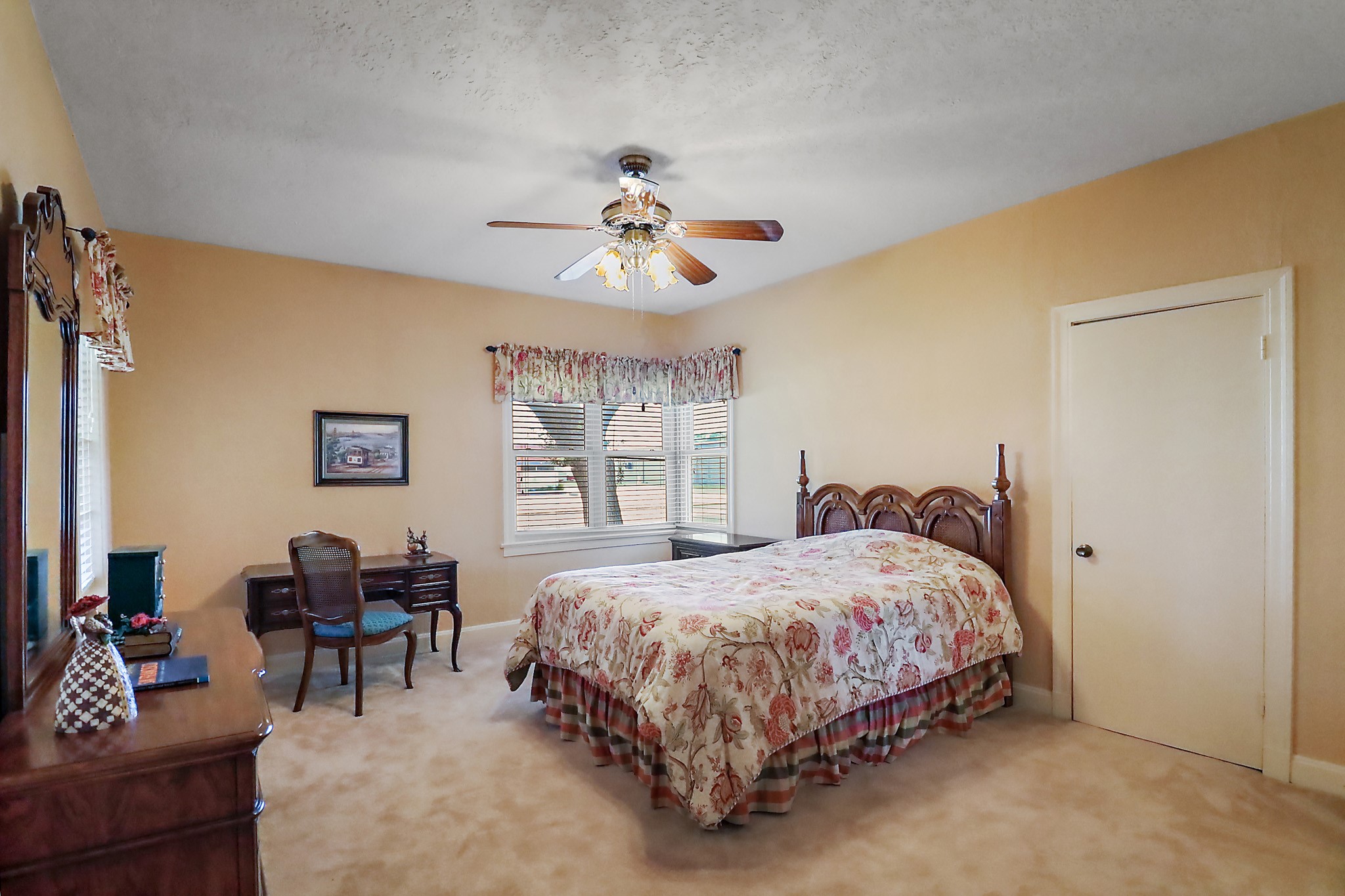 405 Park Street Anahuac, TX 77514 - Photo 19 of 37 a bedroom with a bed and a chandelier