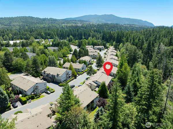 an aerial view of a house with garden space and street view