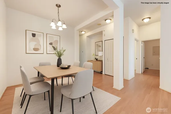 a view of a dining room with furniture and wooden floor