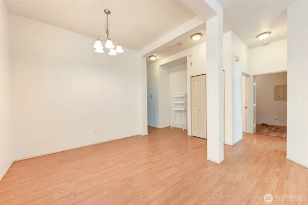 a view of an empty room with wooden floor